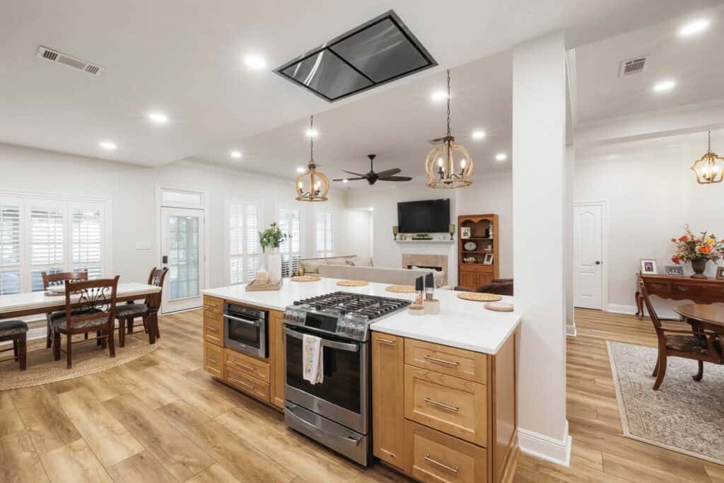 Bright open-concept kitchen with center island, wood floors, and stainless appliances