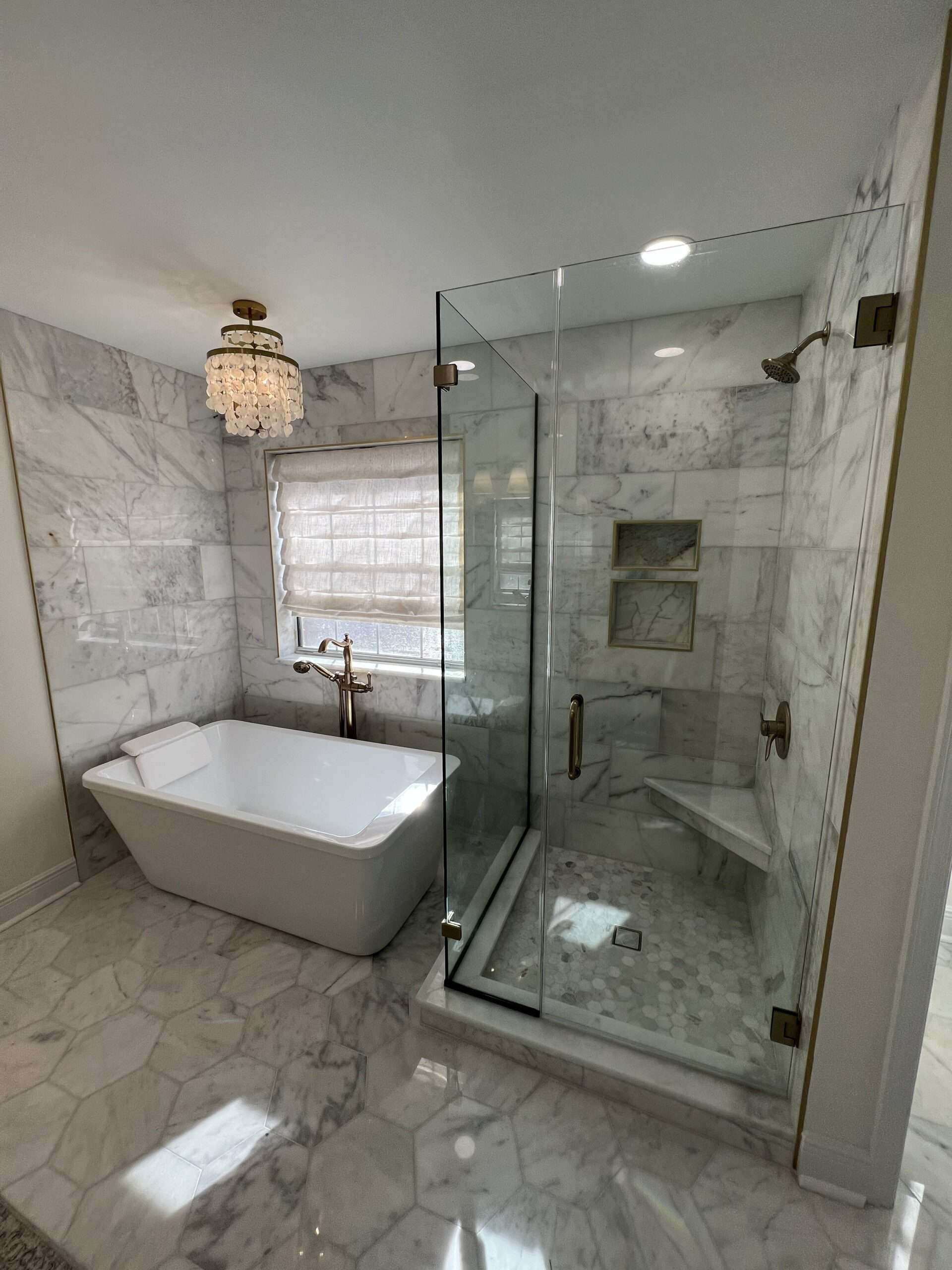 Full view of luxury bathroom with freestanding tub and glass shower