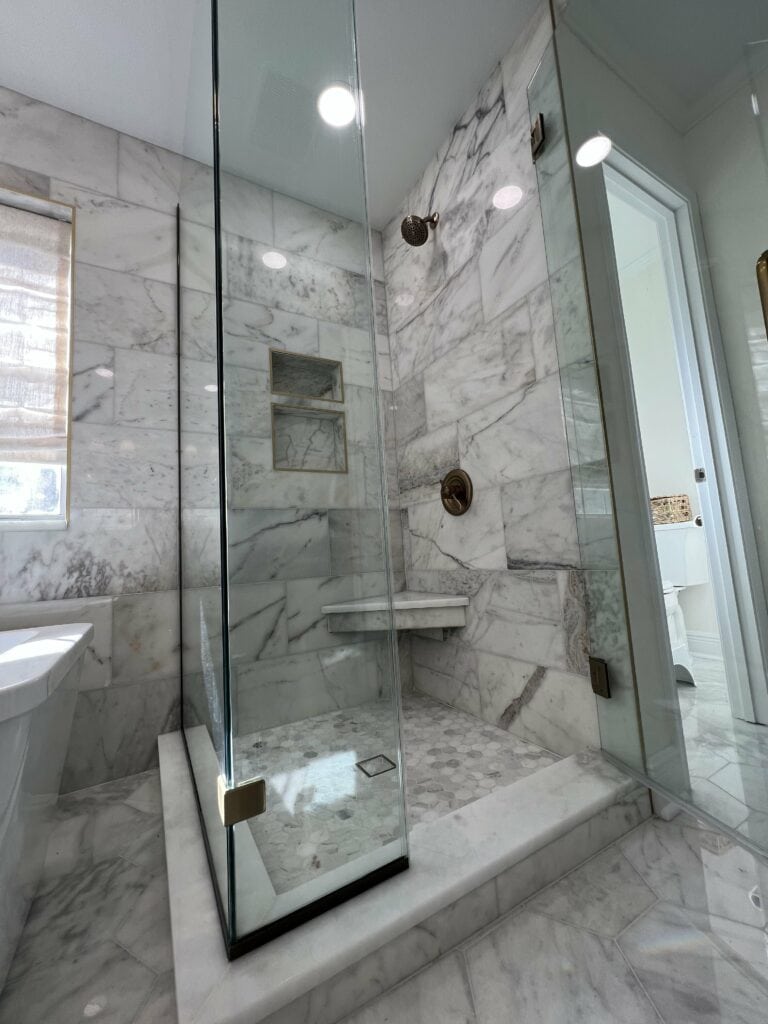 Luxury marble shower with built-in niche and corner bench